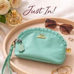 Beautiful Camilla Bowles wristlet pouch in a soft mint green color with elegant